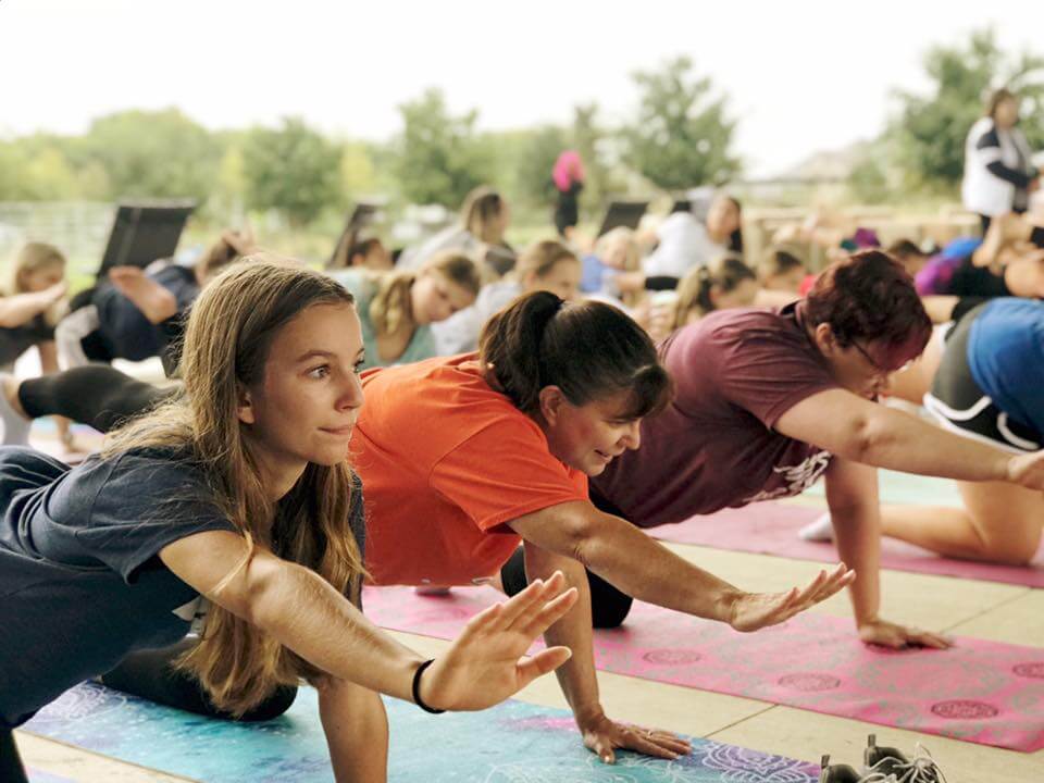 Yoga Residents participate in community yoga outside their new homes in Little Elm, TX